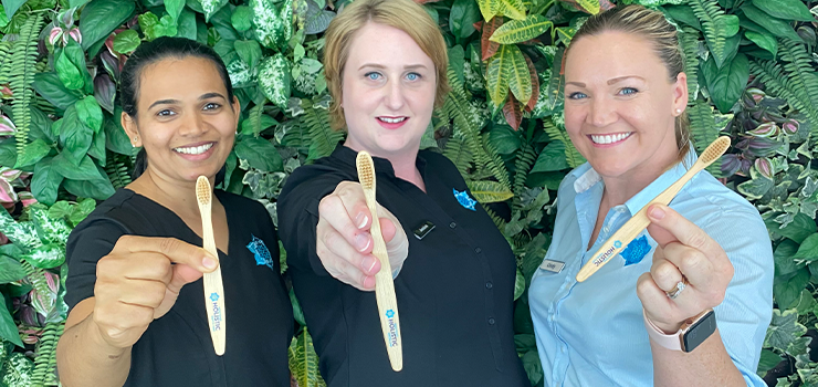 Gold Coast Holistic Dental Care Staff Holding Bamboo Toothbrushes